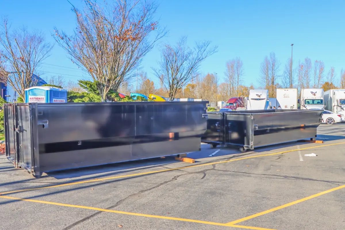 Professional dumpster rental service with roll-off container on residential driveway in Waterbury